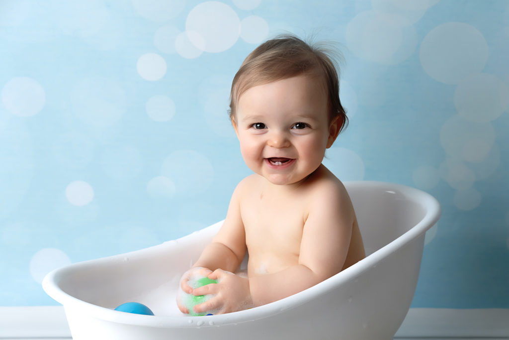 studio photos pour le 1er anniversaire de bébé dans un bain lors d'une séance smash the cake à collonges (01) près des Pays de Gex et de Haute savoie